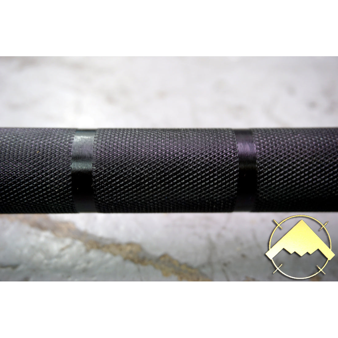 Consistent, Well-Crafted Knurl extends to collar. This barbell features dual lifting marks with no center knurl